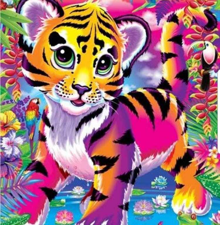 Тигренок держит в лапах